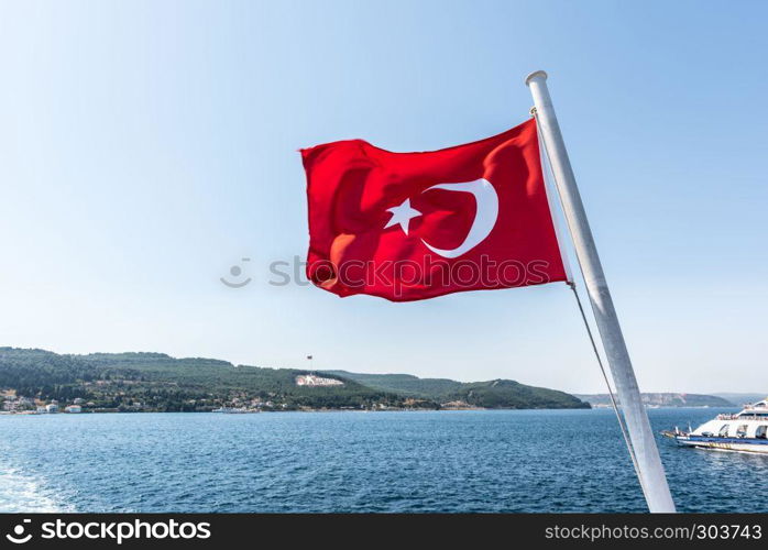 Turkish flag and Dur Yolcu memorial on background in Kilitbahir District,Canakkale,Turkey