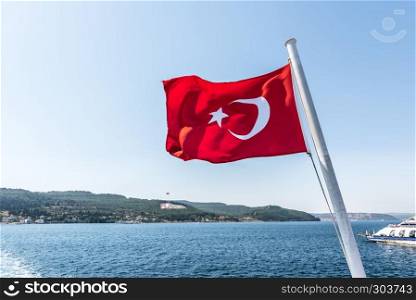 Turkish flag and Dur Yolcu memorial on background in Kilitbahir District,Canakkale,Turkey