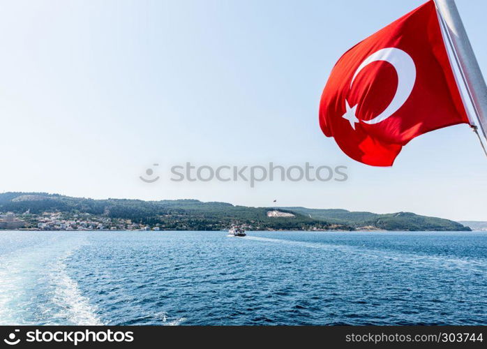 Turkish flag and Dur Yolcu memorial on background in Kilitbahir District,Canakkale,Turkey