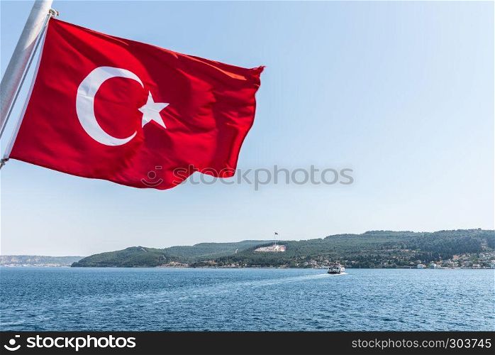 Turkish flag and Dur Yolcu memorial on background in Kilitbahir District,Canakkale,Turkey