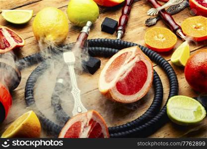 Turkish hookah with orange, lime, lemon and grapefruit. Citrus hookah tobacco. Smoking. Smoking hookah with citrus fruits.