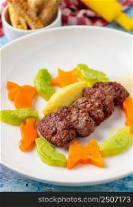 Turkish meatball traditional kofte. with carrots and zucchini cut into animal shapes. Spicy Meatballs Kebab or Kebab