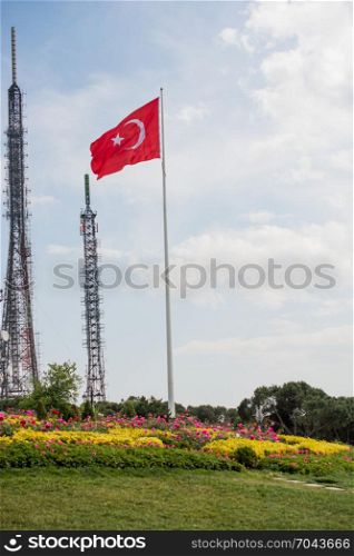 Turkish national flag hang on a pole in open air by the TV tower