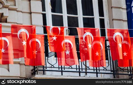Turkish national flags with white star and moon in sky