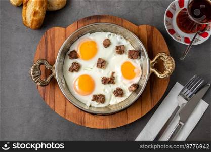 Turkish scrambled eggs Turkish name Kavurmali Yumurta with roasted meat in copper pan