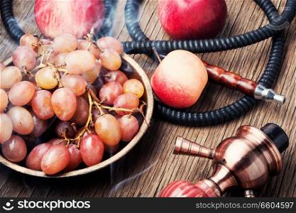 Turkish smoking hookah with taste of a fruit mixture of grapes and apples.Shisha concept. Fruit taste of hookah.. Hookah with autumn grapes