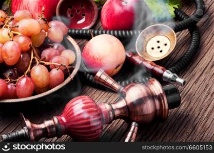Turkish smoking hookah with taste of a fruit mixture of grapes and apples.Shisha concept. Fruit taste of hookah.. Hookah with autumn grapes