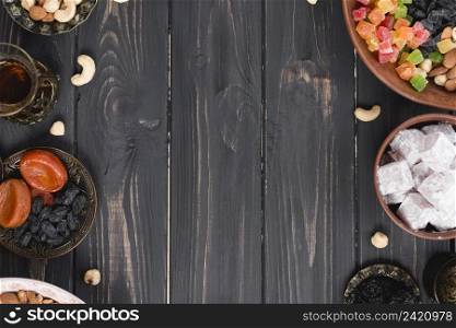 turkish tea dried fruits raisins nuts lukum black textured wooden desk