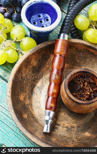 Turkish tobacco hookah with grapes aroma.Kalian with berry. Shisha with grapes flavor