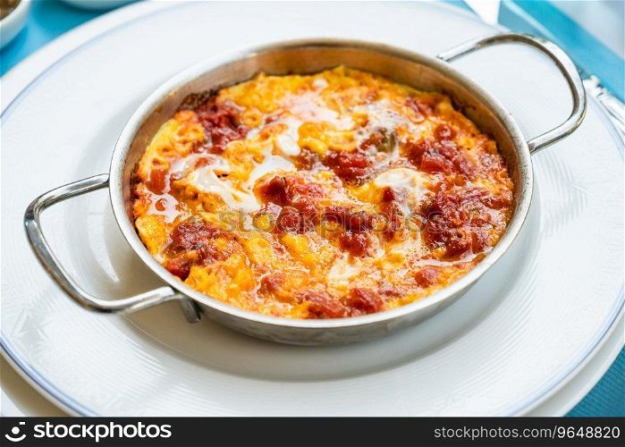 Turkish traditional menemen dish made with eggs, onions, peppers and tomatoes