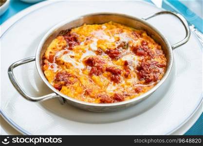 Turkish traditional menemen dish made with eggs, onions, peppers and tomatoes