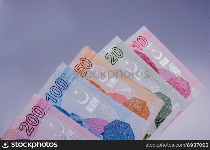 Turksh Lira banknotes of various color, pattern and value on white background