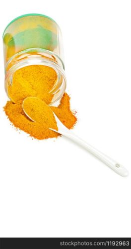 Turmeric pepper powder in glass jar. Heap. Spoon. Isolated on white. Free space for text.