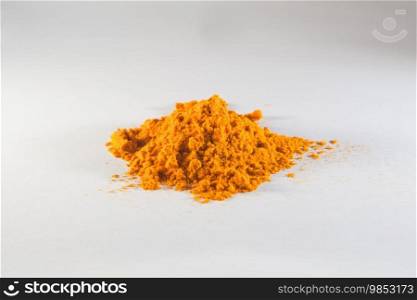 Turmeric powder spice pile isolated on white background 