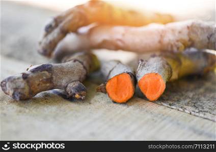 turmeric root plant on wooden table for herbal medicines nature