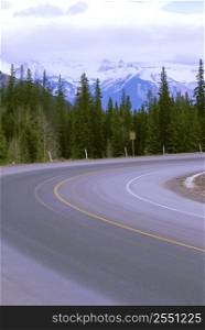 Turn of an empty mountain road in winter