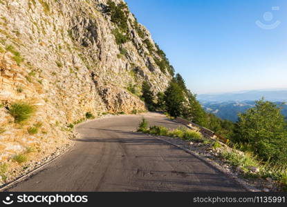 Turn of the road in mountains of Montenegro at sunrise. Turn of the road in mountains