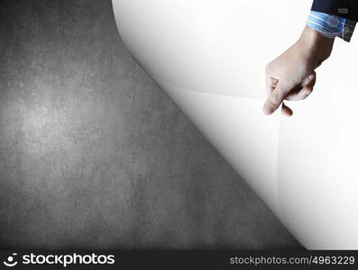 Turning page. Close up of hand turning white sheet of paper. Place for text