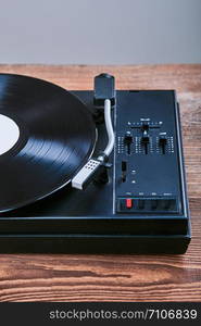 Turntable vinyl player with black vinyl record. Classic stereo set. Candid people, real moments, authentic situations