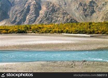 Turquoise blue river flows in the Skardu district. Landscape autumn scene. Gilgit Baltistan, Pakistan.