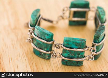 Turquoise bracelet on wooden floor