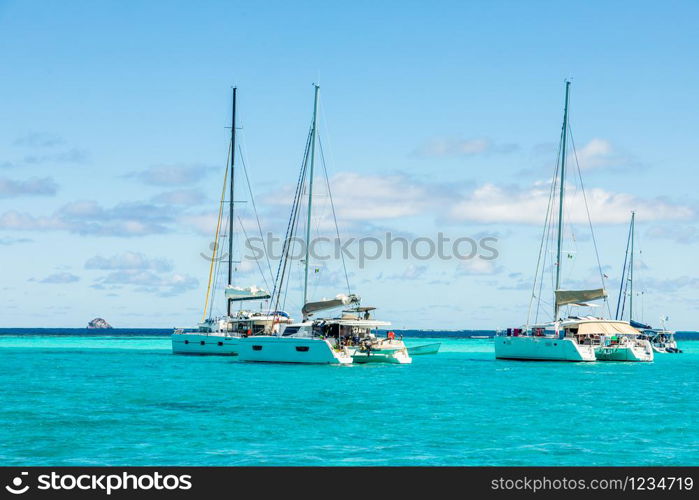 Turquoise colored sea with ancored catamarans, Tobago Cays, Saint Vincent and the Grenadines, Caribbean sea