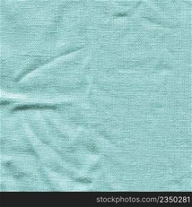 Turquoise fabric background texture. Turquoise background from a textile material. Turquoise color cotton fabric background