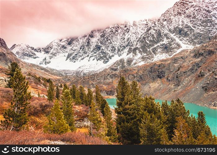 Turquoise lake in mountains. River in rocks in fall. Travel in mountain valley
