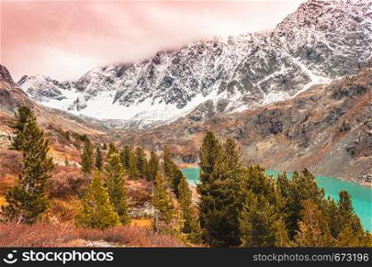 Turquoise lake in mountains. River in rocks in fall. Travel in mountain valley