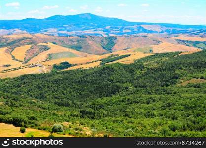 Tuscan Hills Covered With Forests And Plowed Fields