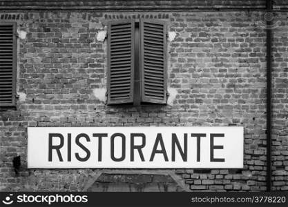 Tuscany, Italy. Italian restaurant sign on an old wall.