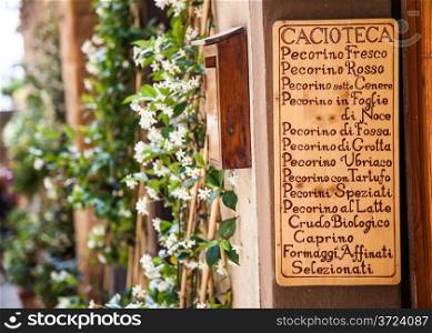 Tuscany, Italy. List of cheeses in front of a traditional cheese shop, said Cacioteca