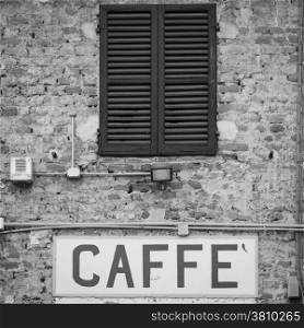 Tuscany, Italy. Old Caffe sign under a traditional Italian window
