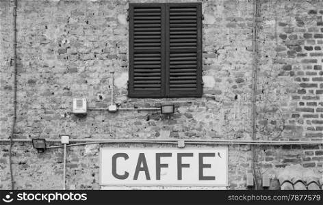 Tuscany, Italy. Old Caffe sign under a traditional Italian window
