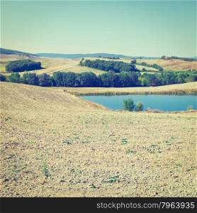 Tuscany Landscape with Pond Surrounded by Plowed Fields in the Autumn, Italy, Instagram Effect