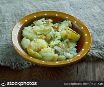 Tushanka- Belarusian potato stew on a wooden background