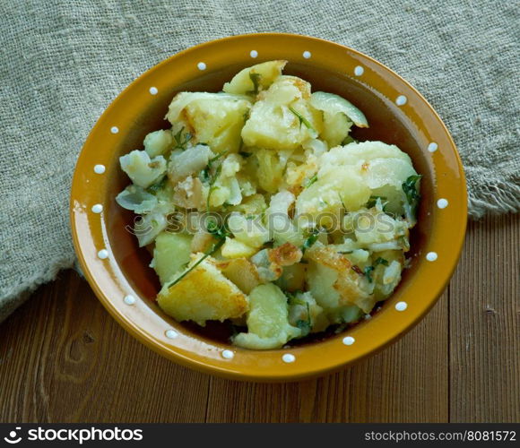 Tushanka- Belarusian potato stew on a wooden background