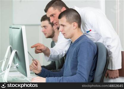 tutor and young students in computing class