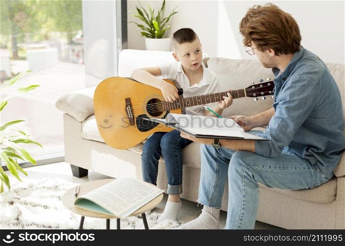 tutor boy learning guitar from home