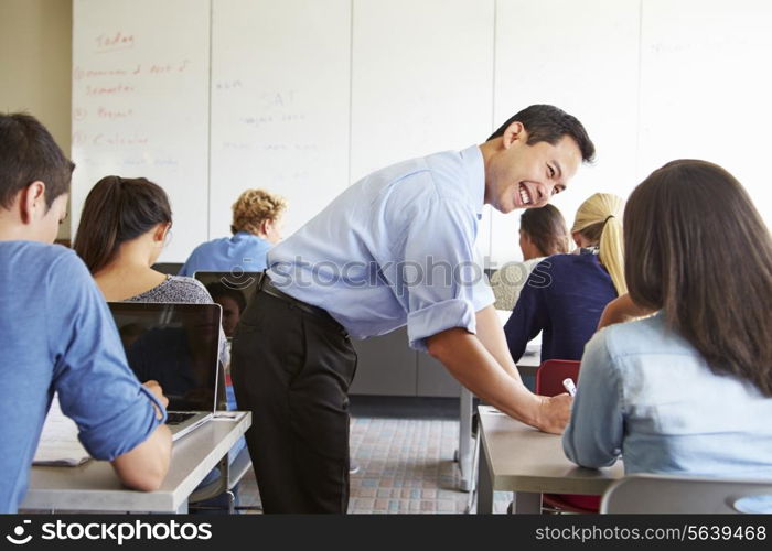 Tutor Helping High School Students In Class