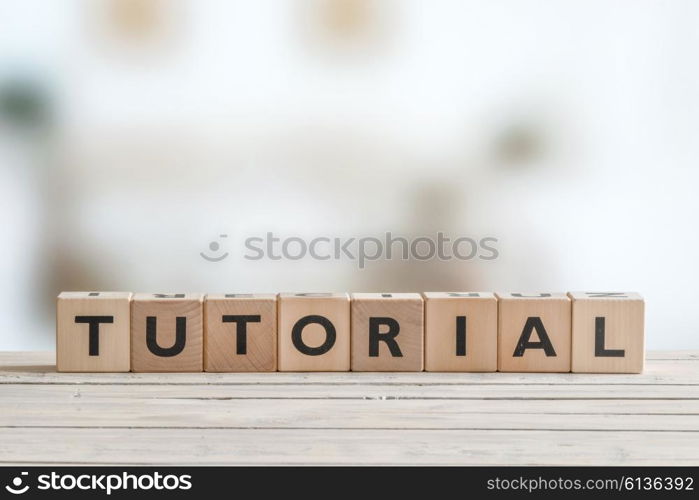 Tutorial sign made of cubes on a wooden table