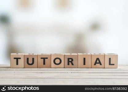 Tutorial sign made of cubes on a wooden table