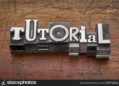tutorial word in mixed vintage metal type printing blocks over grunge wood