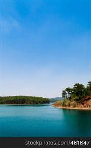 Tuyen Lam lake or Ho Tuyen Lam and pine forest, blue water in Da Lat - Vietnam with blue sky in spring season