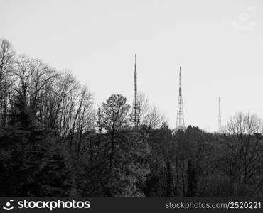 TV broadcasting towers on the hills in Turin, Italy in black and white. TV broadcasting towers in black and white