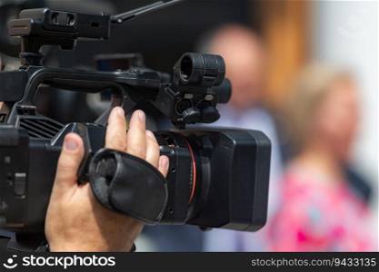 TV camera records a press conference, providing comprehensive media coverage and capturing important moments . Media Coverage  TV Camera Records Press Conference