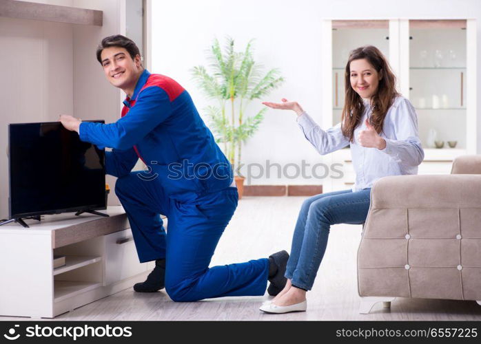 Tv repairman technician repairing tv at home