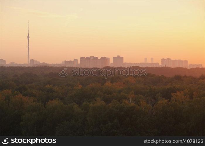 TV tower and urban houses in summer yellow sunrise in early morning, Moscow