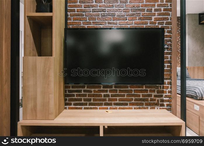 TV with blank screen and shelf cabinet at night, interior design