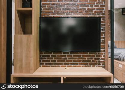 TV with blank screen and shelf cabinet at night, interior design